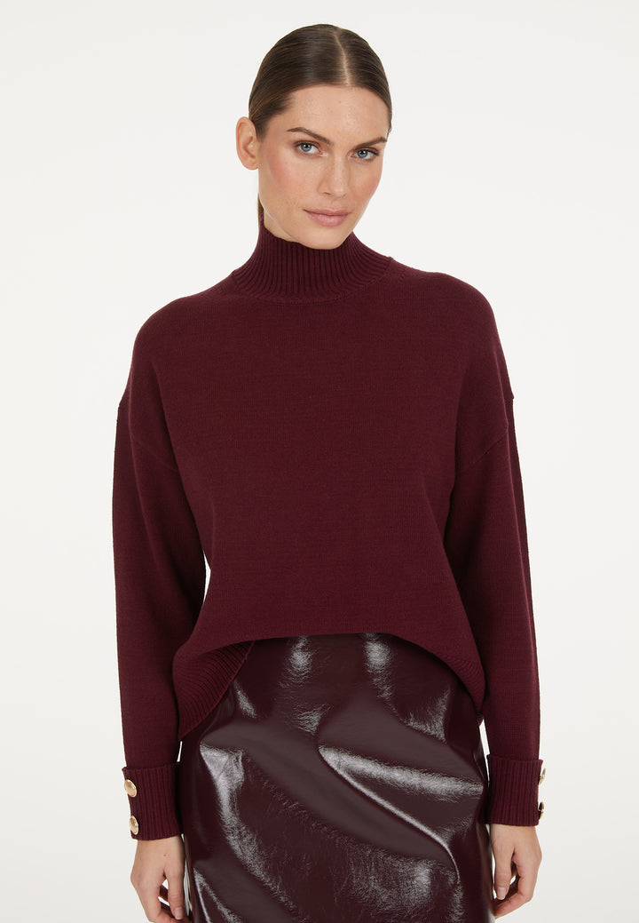 Pull avec boutons aux poignets et col montant