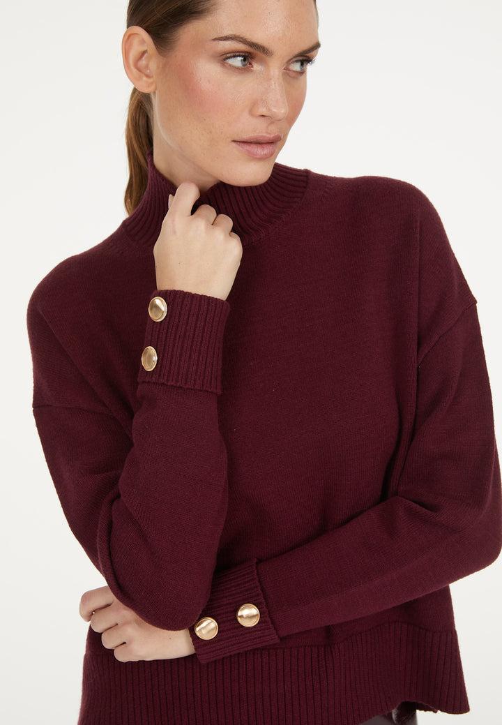 Pull avec boutons aux poignets et col montant