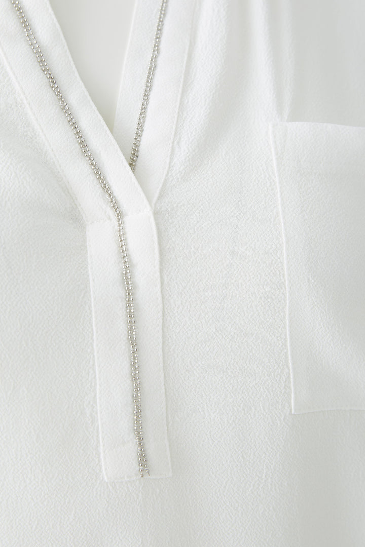 Blouse fluide à col V avec détail perlé